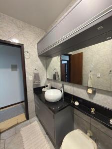 a bathroom with a sink and a mirror at Casa para oktoberfest em Blumenau in Blumenau +7 photos