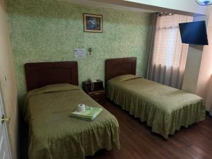 a room with two beds in a hotel room at HOTEL Centro de la ciudad de La Paz in La Paz