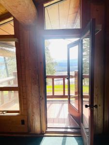 an open door to a porch with a view at Living Well Lodge with Panoramic Views in Moyie Springs