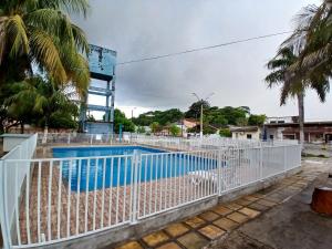 a white fence around a swimming pool at Casa COP30 in Ananindeua