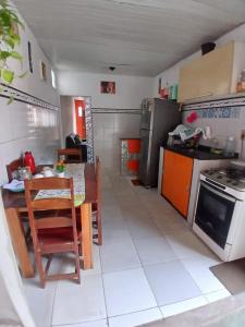 a kitchen with a table and a dining room at Casa COP30 in Ananindeua