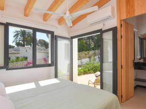 a bedroom with a bed and a ceiling fan at Bonita stay B Sky Piscina caliente, vistas, wifi in Jávea +42 photos