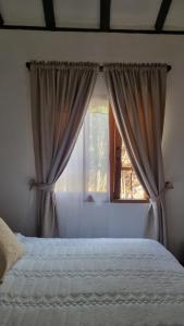 a bedroom with a bed and a window at La Casa De La Abuela in Villa de Leyva