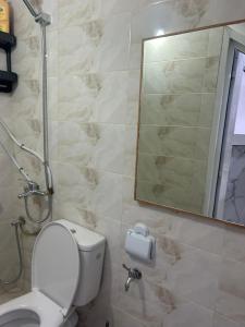 a bathroom with a toilet and a mirror at Studio cozy 04 in Tangier +9 photos