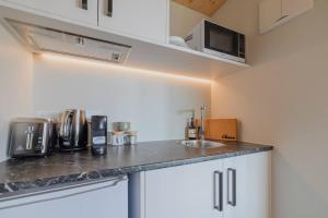 a small kitchen with a sink and a microwave at Benmore Hideaway Cozy Room with Mini Kitchenette in Lake Tekapo