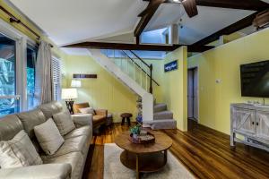 a living room with a couch and a tv at Mountain Home near Blue Ridge Parkway, Central Location! in Blowing Rock