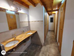 a bathroom with two sinks and a large mirror at ChacraKremen in El Bolsón +72 photos