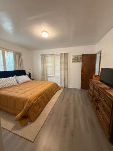 a bedroom with a bed and a flat screen tv at Union Street Bungalow in Saint Joseph