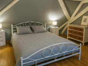 a bedroom with a large bed and two night stands at Maison à Colombages au Cœur du Vignoble Alsacien avec Parking et Chauffage Inclus - FR-1-744-23 in Ammerschwihr
