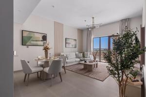 a living room with a couch and a table at F1 Yas Luxury 1BR Golf&Water View w tkt discount in Abu Dhabi