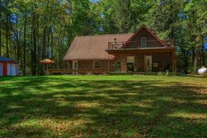 a house sitting on top of a lush green field at Pet Friendly Wi-Fi Firepit TV in Sigel