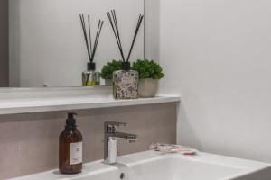 a bathroom sink with a bottle of soap on it at Luxury 1br Yas Island, Golf & Water Views!near F1 in Abu Dhabi +22 photos