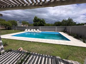 a swimming pool in the backyard of a house at ALMAS CASAS de SIERRAS in San Lorenzo