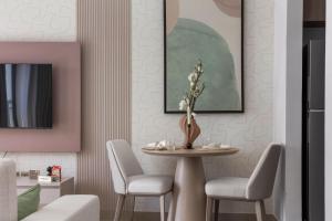 a dining room with a table and chairs at F1 Chic Yas Studio Park Discounts! Near Yas Golf in Yas Island