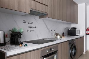 a kitchen with a sink and a counter top at F1 Chic Yas Studio Park Discounts! Near Yas Golf in Yas Island +24 photos