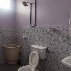 a bathroom with a toilet and a sink at Mastermind Malay Semeling Homestay in Bedung +8 photos