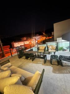 a rooftop patio with couches and chairs at night at Casa em Capitólio in Capitólio