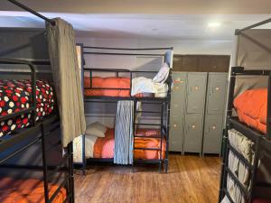 a room with four bunk beds in a room at Tlv HOSTEL in Cusco