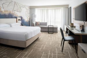 a bedroom with a bed and a desk and a couch at Tampa Airport Marriott in Tampa +46 photos