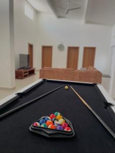 a pool table with a tray of balls on it at Izzys in Zanzibar City