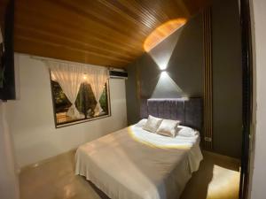 a small bedroom with a bed in a room at Le”More House in Girardot +10 photos