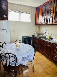 a kitchen with a table and chairs and a refrigerator at Jardim das Pérolas 101 in Belém +13 photos