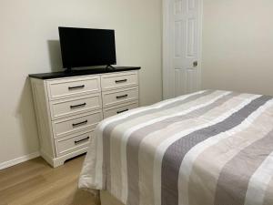 a bedroom with a dresser with a television on it at Beach Haven West Lagoon Front Property Pets Accepted With Wifi in Beach Haven West