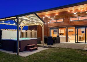 a pavilion with a hot tub in a backyard at Fairview Lodges in Hollym