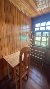 a wooden table and a chair in a room at CABAÑAS RANCH OXaPAMP4 in Oxapampa