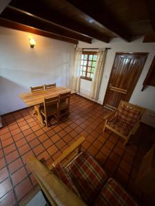 a living room with a wooden table and chairs at Pucon Antu I - De la Montaña in Esquel