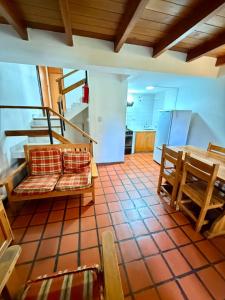 a kitchen with a couch and a table in a room at Pucon Antu I - De la Montaña in Esquel