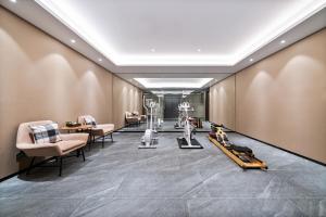 a salon with exercise equipment on a wall at YUNlK Hotel in Harbin