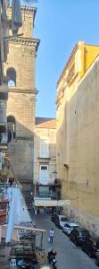 a group of cars parked in a street next to buildings at San Gregorio Suite&Rooms in Naples