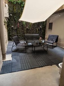 a patio with two chairs and a table and a white tent at San Gregorio Suite&Rooms in Naples