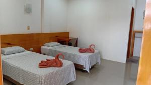 a room with two beds with red towels on them at Freedive Panglao Resort in Panglao Island