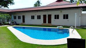 a swimming pool in front of a house at Freedive Panglao Resort in Panglao Island +5 photos