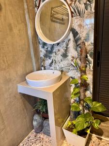 a bathroom with a sink and a mirror at LoftVibes San Juan - 2 in San Juan +8 photos