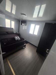 a bedroom with a bed in a room with windows at Villa Mi casita el paraiso costero in Aguada +31 photos