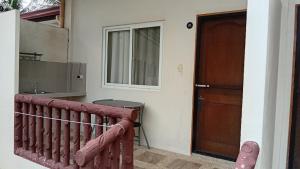 a room with a door and a table and a window at Freedive Panglao Resort in Panglao Island