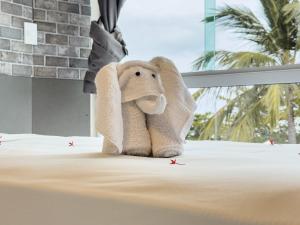 a stuffed elephant sitting on top of a bed at Pousada da Orla in Maragogi