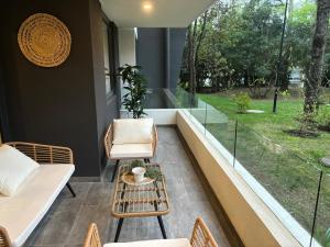 a room with a couch and chairs and a table at Pucon Infinity Camino al Volcán in Pucón