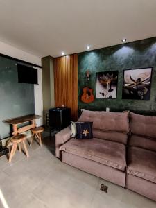 a living room with a couch and a piano at Amoras flat in Sao Jorge