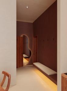 a bedroom with brown walls and a bed with a mirror at Gate 11 Apartments in Denpasar +2 photos