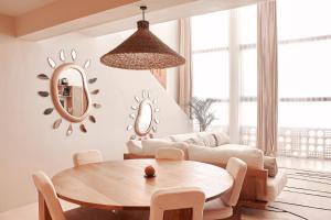 a living room with a table and a couch at Gate 11 Apartments in Denpasar