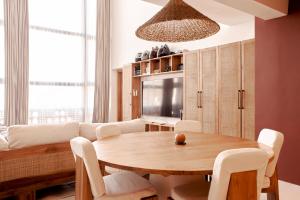 a living room with a table and a couch at Gate 11 Apartments in Denpasar
