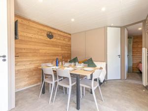 a dining room with a table and white chairs at Chalet confortable 6 personnes en nature - FR-1-840-53 in Aussois