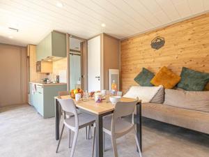 a kitchen and dining room with a table and a couch at Chalet lumineux 4 pers à Aussois avec transats - FR-1-840-57 in Aussois