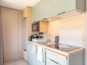 a kitchen with a sink and a counter top at Chalet lumineux 4 pers à Aussois avec transats - FR-1-840-57 in Aussois