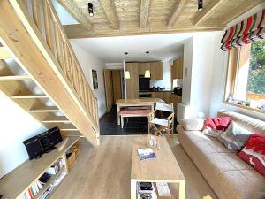 a living room with a couch and a table at Bel appartement à Méribel, balcon, 3 min. télésiège et commerces - FR-1-411-997 in Mussillon