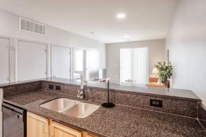 a kitchen with a sink and a counter top at CozySuites at Current the Banks gym pool 01 in Cincinnati +15 photos
